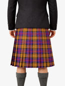 Person wearing a black jacket and a plaid kilt on a white background