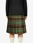 Person wearing a black jacket and green plaid kilt on a white background