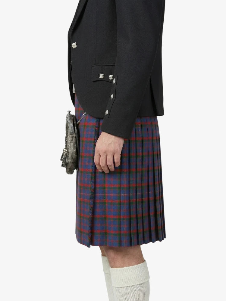 Person wearing a black jacket and red plaid kilt on a white background