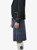 Person wearing a dark blazer and blue plaid kilt on a white background