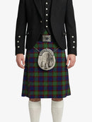 Person wearing a traditional Scottish kilt with a tartan pattern on a white background