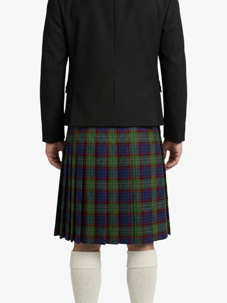 Person wearing a black jacket and plaid kilt on a white background