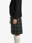 Person wearing a black jacket and a green plaid kilt on a white background