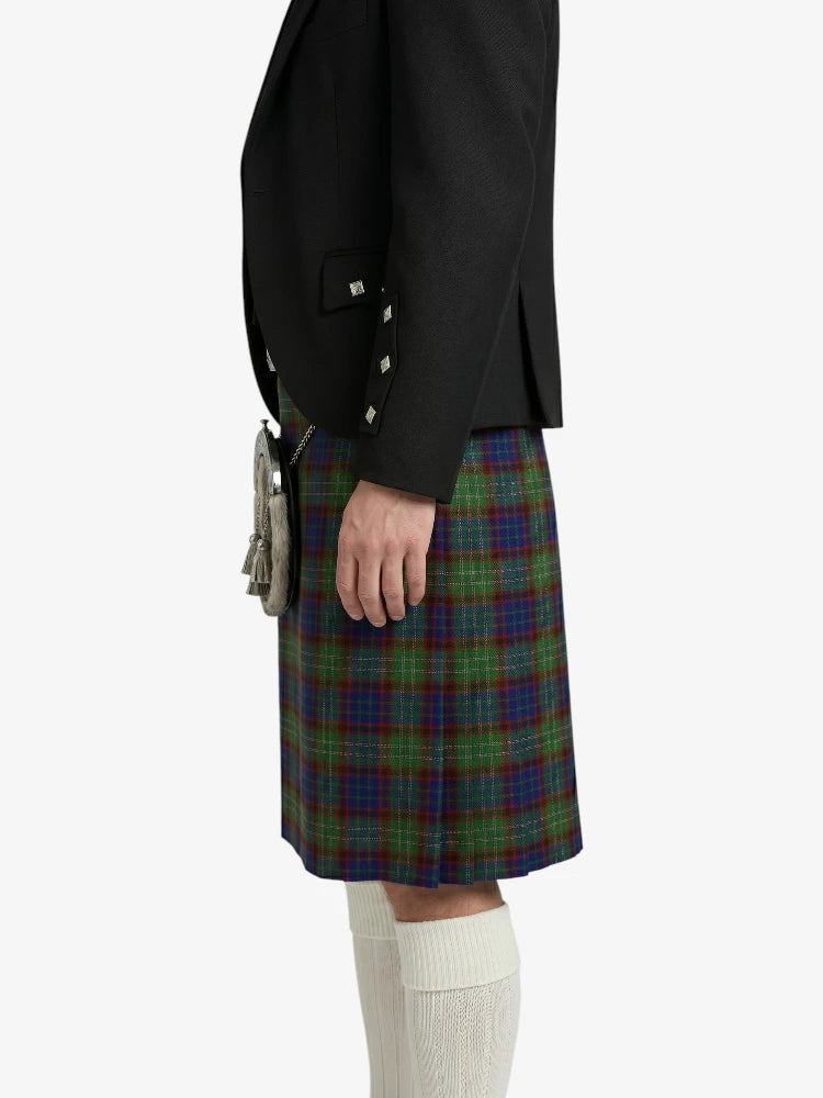 Person wearing a black jacket and a green plaid kilt on a white background