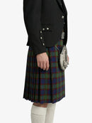 Person wearing a black jacket and tartan kilt on a white background