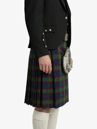 Person wearing a black jacket and tartan kilt on a white background