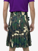 Person wearing a camouflage kilt with a purple shirt on a white background
