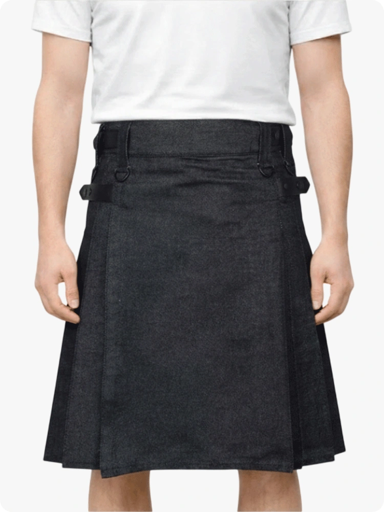 Person wearing a black denim skirt with a white shirt on a plain background