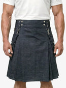 Person wearing a dark blue kilt with silver buttons on a plain background