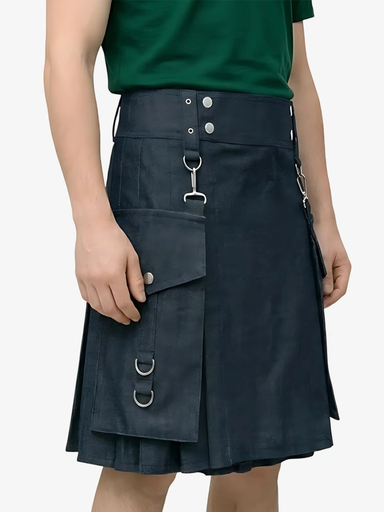 Person wearing a dark blue kilt with metal rings on a plain background