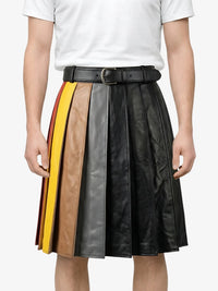 Person wearing a black leather skirt with color-blocked sides on a white background