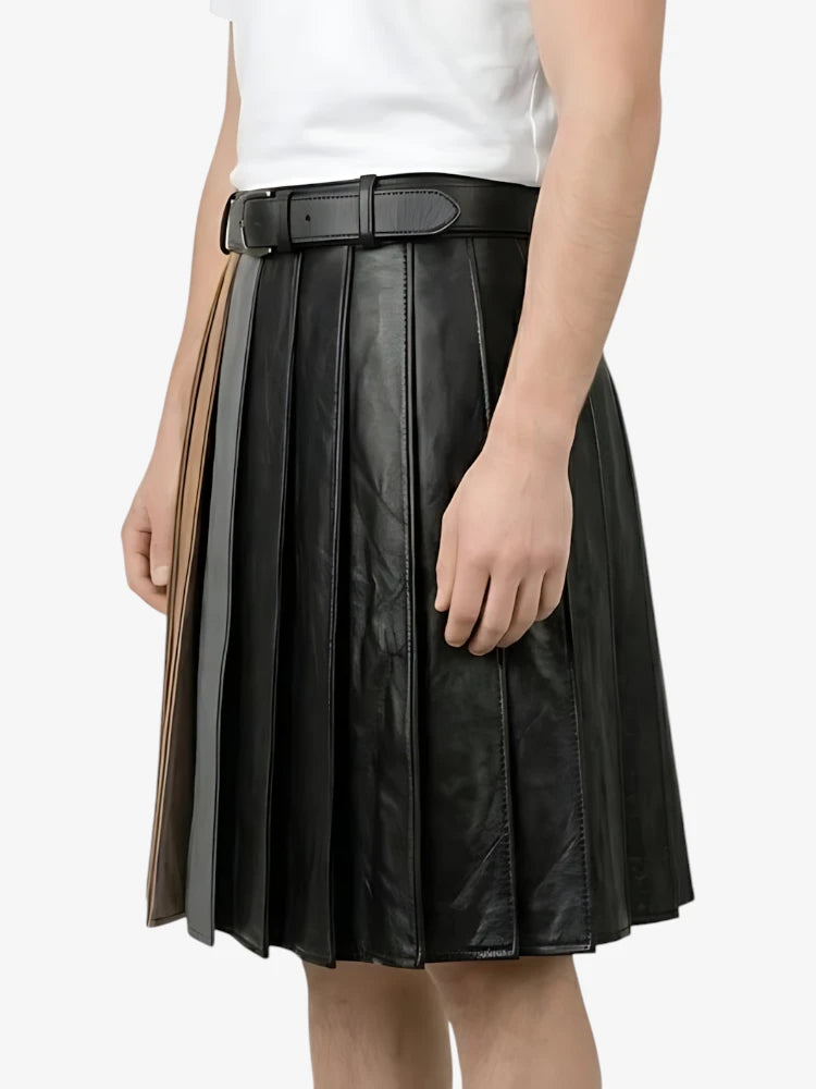 Black pleated leather skirt worn by a person on a white background