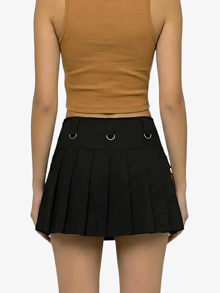Person wearing a brown crop top and black pleated skirt on a white background
