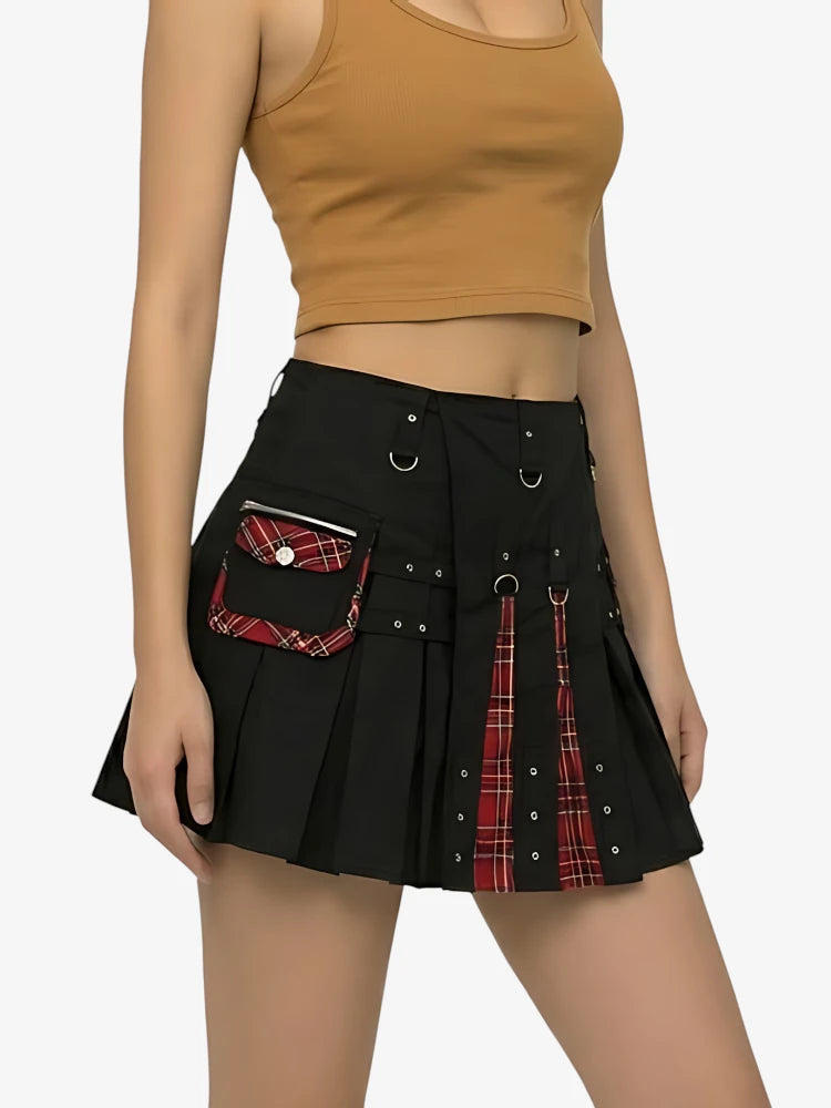 Person wearing a black skirt with plaid accents on a white background