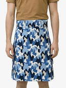 Person wearing a blue camouflage skirt on a white background