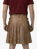 Person wearing a brown pleated skirt with a red shirt on a white background