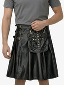Person wearing a black leather kilt with gold accents on a white background