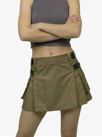 Person wearing a khaki skirt with multiple pockets on a white background