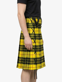 Person wearing a yellow plaid skirt on a white background