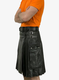 Person wearing an orange shirt and black leather kilt on a white background