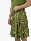 Person wearing a green camouflage kilt on a white background