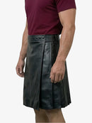 Black leather kilt worn by a person on a white background