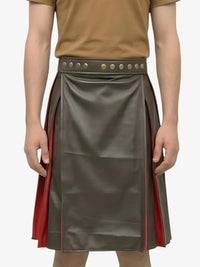 Person wearing a green leather skirt with red accents and a brown top on a white background