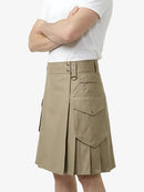 Person wearing a beige pleated skirt with a white top on a light gray background
