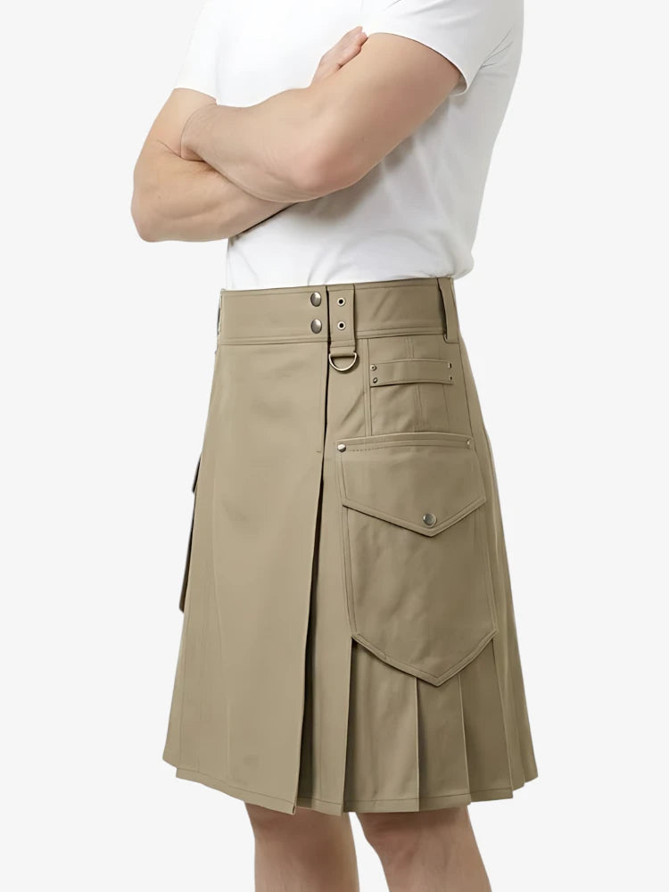 Person wearing a beige pleated skirt with a white top on a light gray background