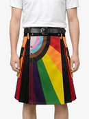 Person wearing a colorful striped skirt with a white shirt on a plain background