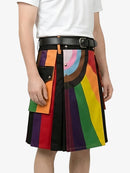 Colorful kilt with rainbow pattern worn by a person on a white background