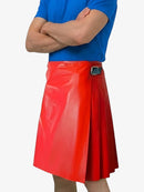Person wearing a blue shirt and red pleated skirt on a white background