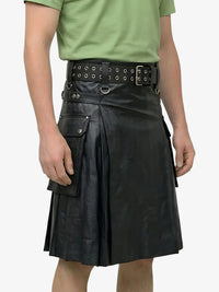 Person wearing a black leather kilt with a green shirt on a white background
