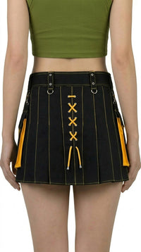Black and yellow pleated skirt worn by a person on a white background