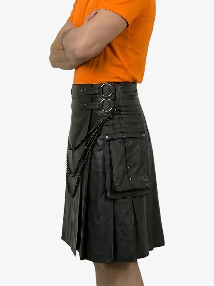 Person wearing a black leather kilt with orange shirt on a white background