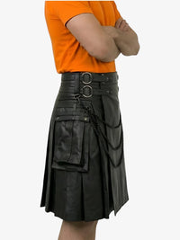 Person wearing a black leather kilt with orange shirt on a white background