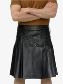 Person wearing a black leather kilt with a plain background