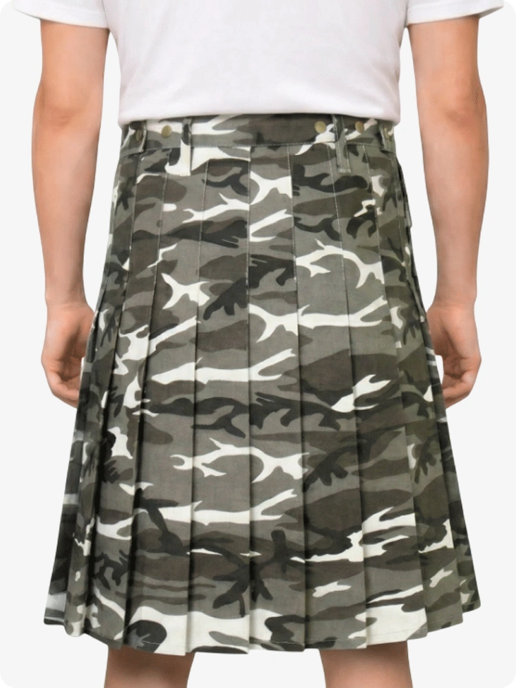Camouflage pleated skirt worn by a person on a plain background