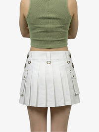 Person wearing a green crop top and white pleated skirt on a white background