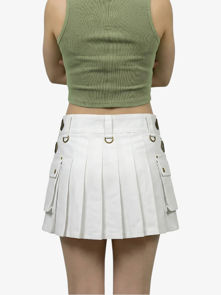 Person wearing a green crop top and white pleated skirt on a white background