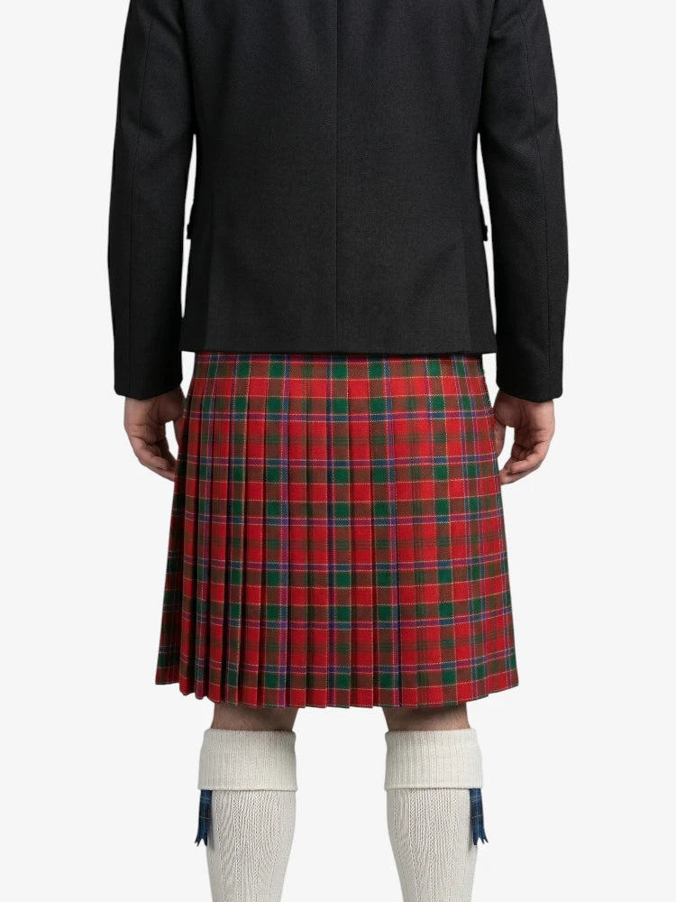 Person wearing a black jacket and red plaid kilt on a white background