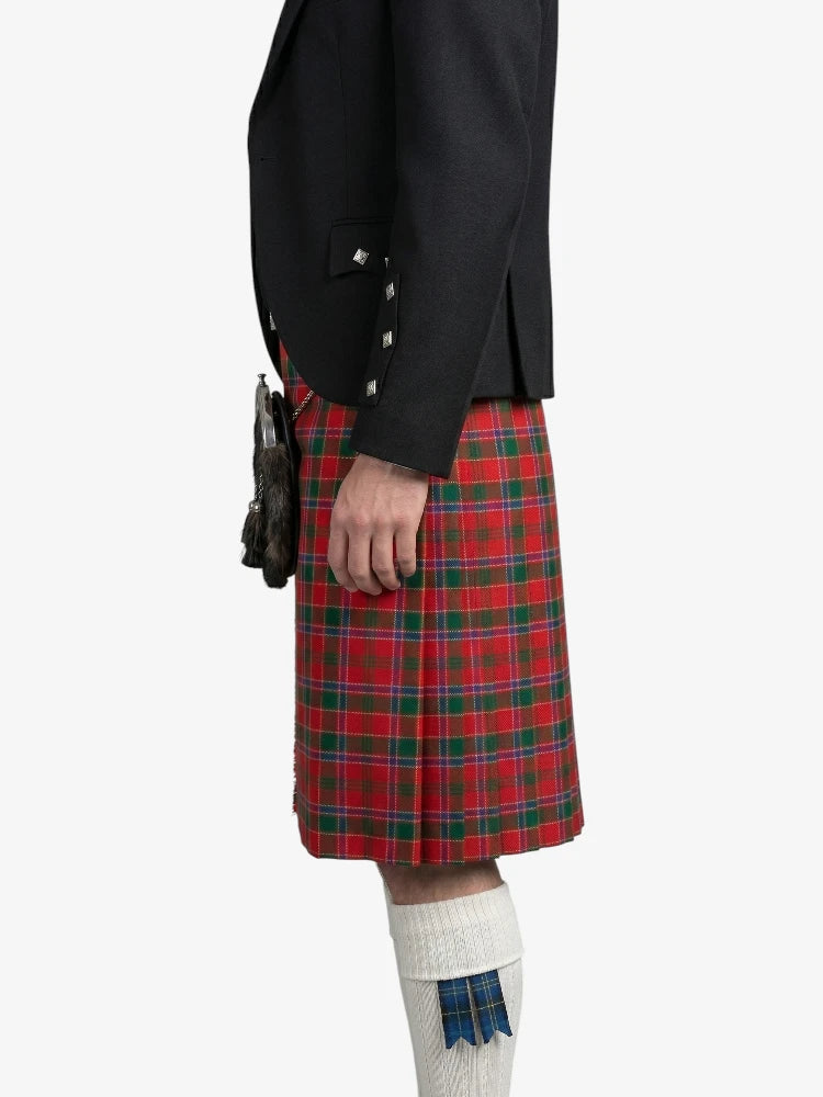 Person wearing a black jacket and red plaid kilt on a white background
