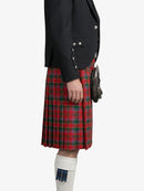 Person wearing a red plaid kilt with a black jacket on a white background