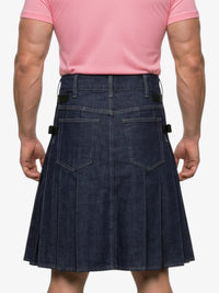 Person wearing a pink shirt and denim kilt on a white background