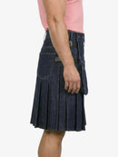 Person wearing a blue denim kilt on a white background