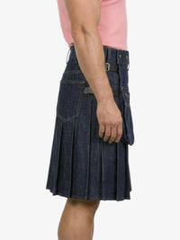 Person wearing a blue denim kilt on a white background
