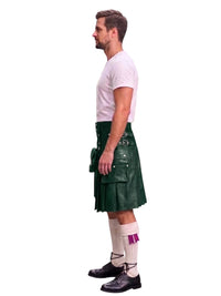 A man shown in profile wearing a dark green leather kilt with multiple utility pockets, a white t-shirt, white socks, and black leather shoes, set against a plain white background.