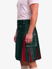 A man wearing a dark green faux-leather kilt with red pleated side panels, paired with a white t-shirt and white socks, shown from the waist down against a light gray background.