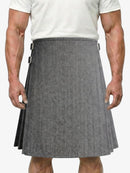 Person wearing a gray herringbone kilt on a white background