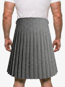 Person wearing a gray pleated kilt on a white background